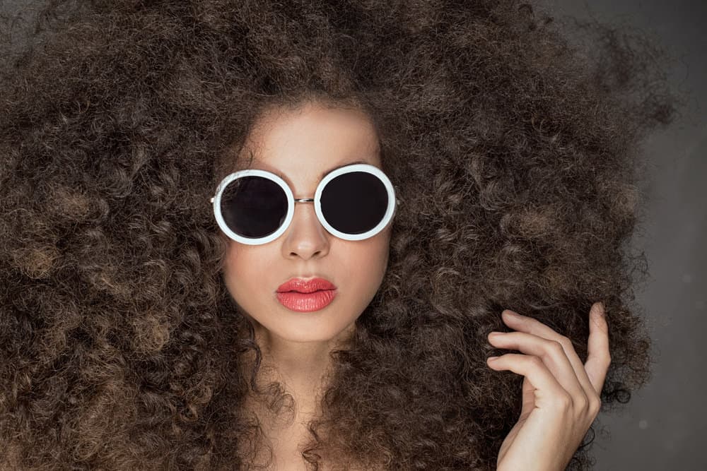 woman with very curly hair and white sunglasses sept6 Woman with very curly hair and white sunglasses