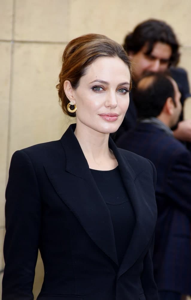 Angelina Jolie attended the 2012 Golden Globe Foreign Language Film Panel Discussion held at the Egyptian Theatre in Hollywood, USA on January 14, 2012. She wore a black smart casual outfit to pair with her bun hairstyle that has subtle highlights.