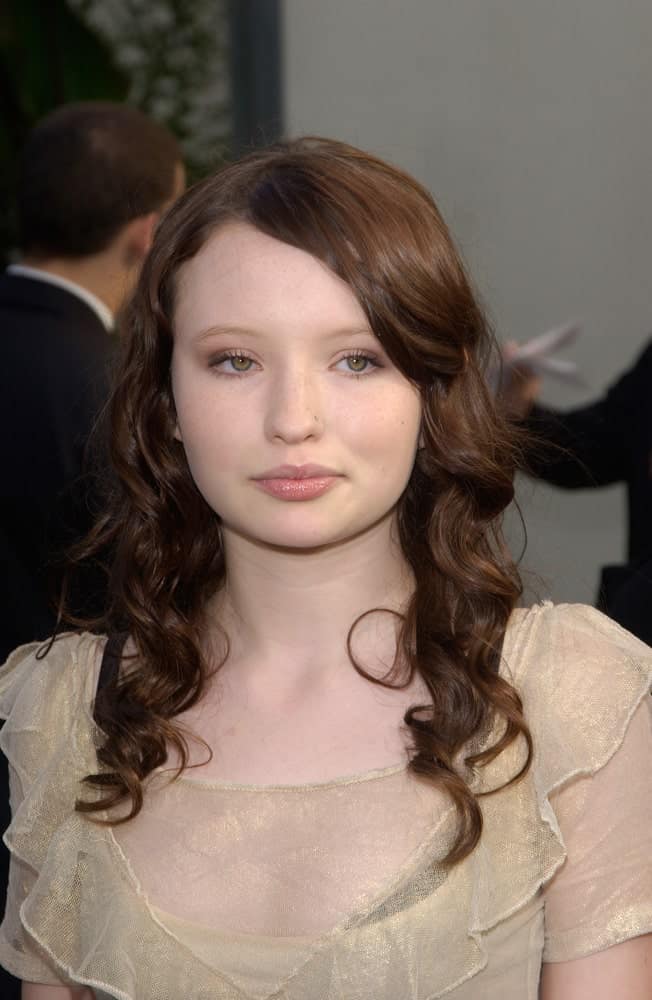 Actress Emily Browning was at the December 12, 2004 world premiere, in Hollywood, of her new movie Lemony Snicket's A Series of Unfortunate Events. She wore a charming beige dress with her long and curly brunette hairstyle that has layers and long side-swept bangs.