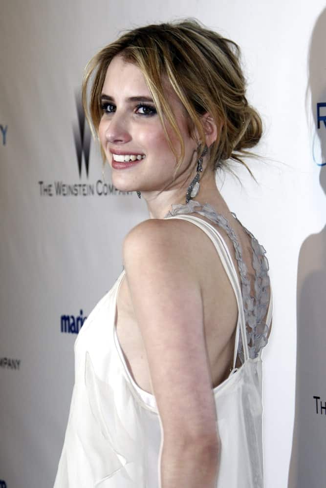 Emma Roberts was at The Weinstein Company And Relativity Media's 2011 Golden Globe Awards Party at Beverly Hilton Hotel on January 16, 2011 in Beverly Hills, CA. She paired her pearly white dress with a messy and highlighted low bun hairstyle with loose bangs.