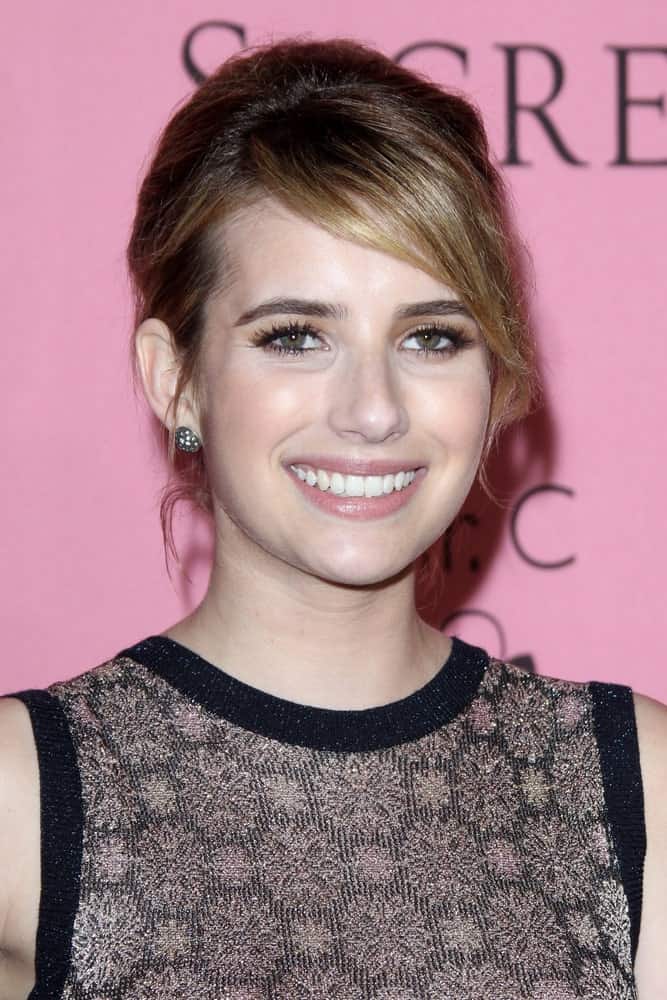 Emma Roberts was at the Victoria's Secret What Is Sexy? Party at Mr. C Beverly Hills on May 10, 2012 in Beverly Hills, CA. She wore an elegant dress that she topped with a brunette bun hairstyle with long side-swept bangs.