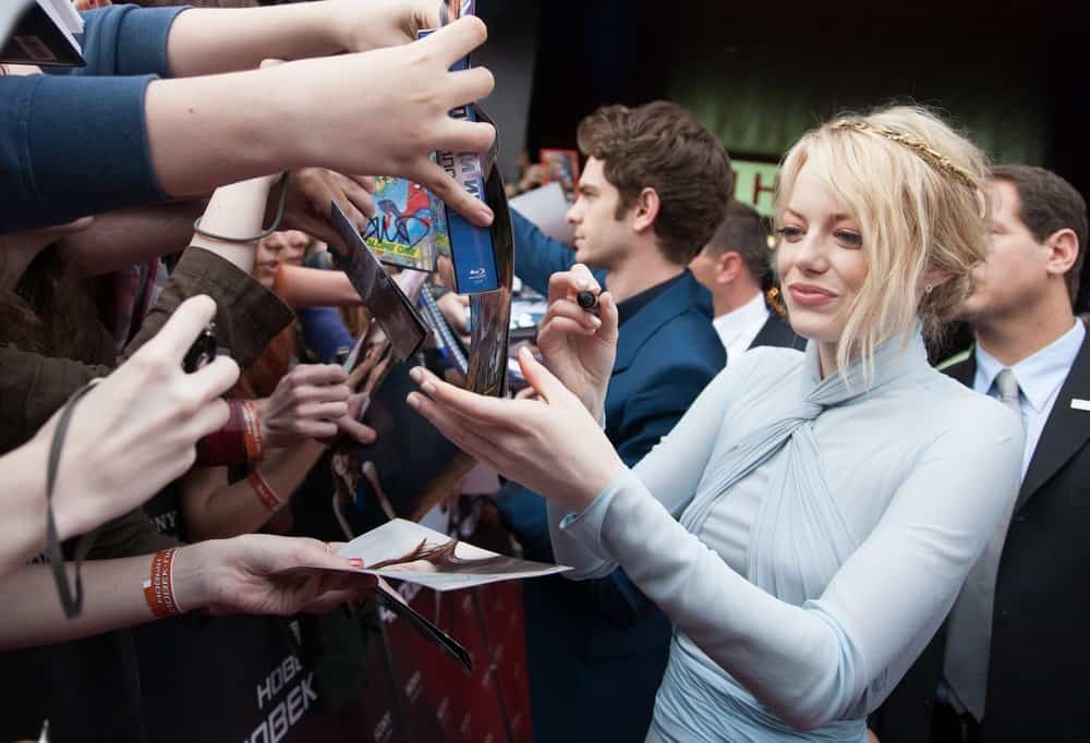 Actress Emma Stone decorated her blond messy low bun hair with a golden accessory at the premiere of the movie "The Amazing Spider-Man" on June 15, 2012 at the OCTOBER CINEMA in Moscow, Russia.