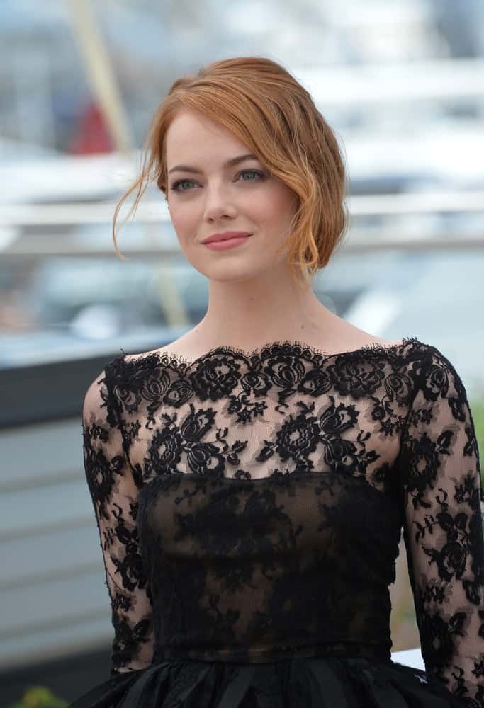 Emma Stone caught everyone's attention with her stunning black sheer cocktail dress and loose half-up hairstyle with highlights at the photocall for her movie "Irrational Man" at the 68th Festival de Cannes on May 15, 2015.
