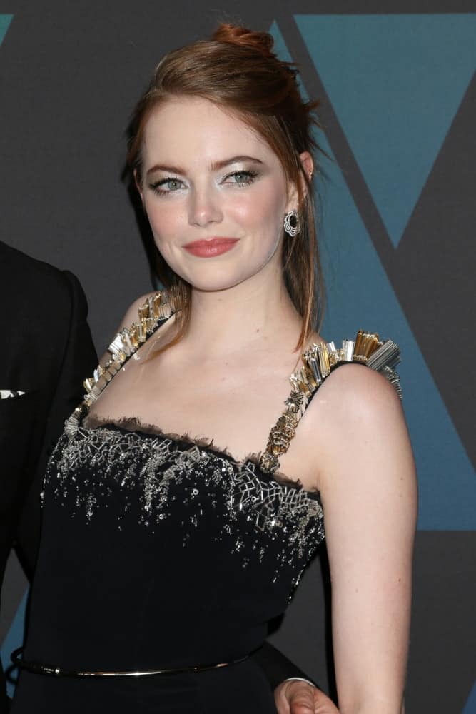 Emma Stone wowed everyone with her lovely black dress and messy bun hairstyle that has thin tendrils on the sides at the 10th Annual Governors Awards at the Ray Dolby Ballroom on November 18, 2018 in Los Angeles, CA.