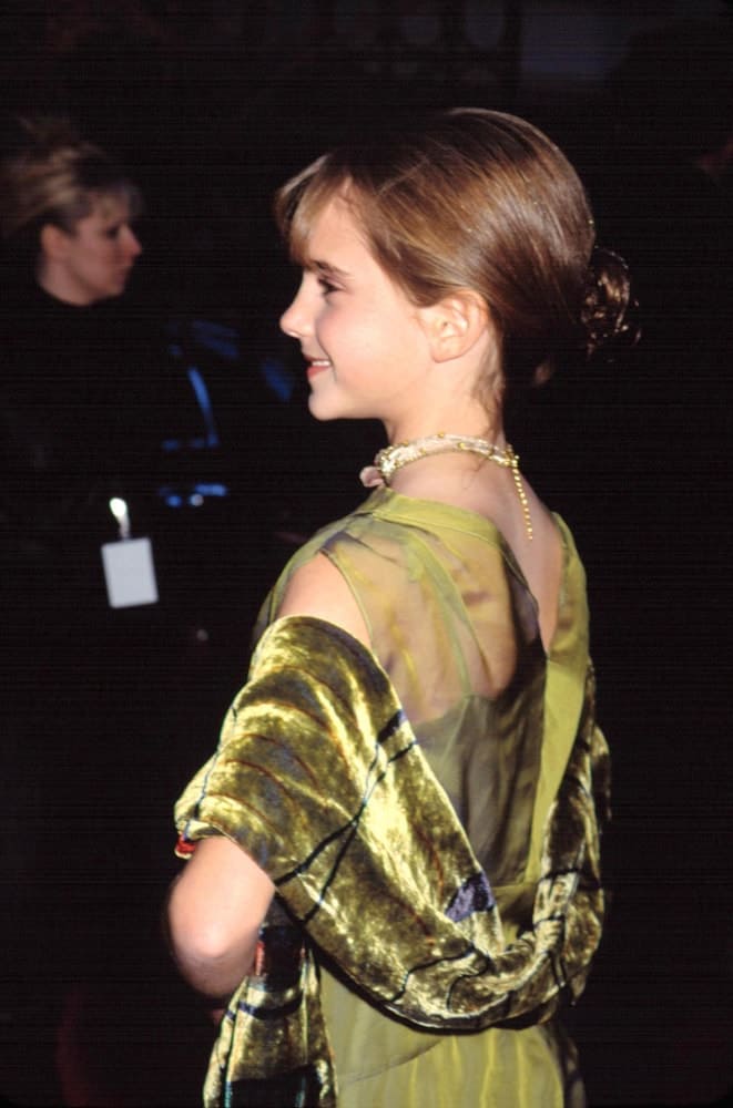 The young actress, Emma Watson, attended the premiere of "Harry Potter and the Sorcerer's Stone" in New York City on November 11, 2001. She was elegant in her green dress and bun hairstyle with loose short bangs.