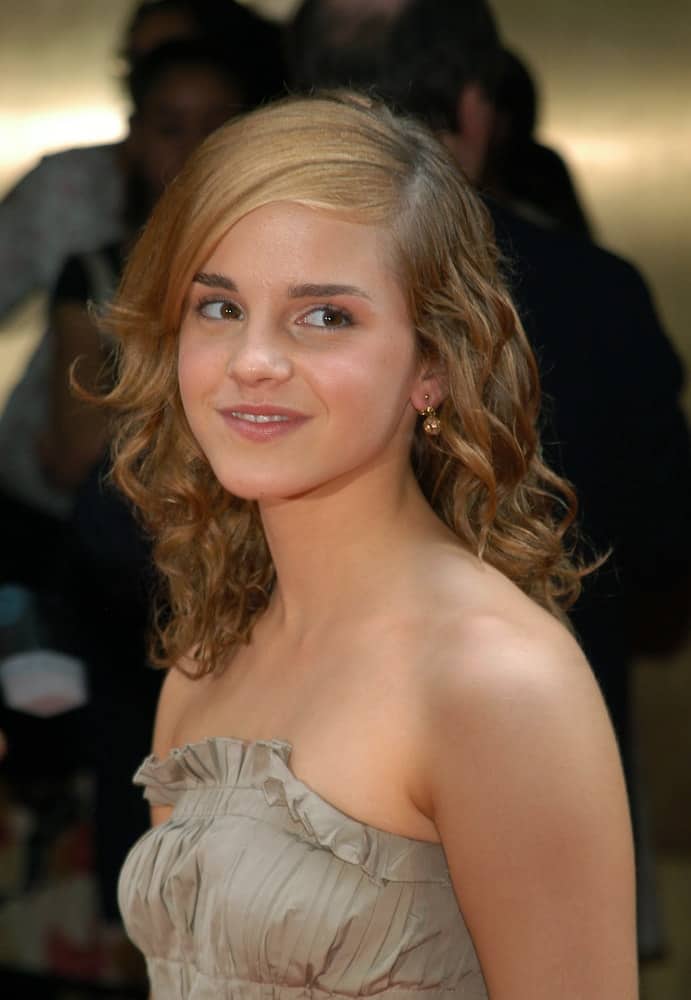 Actress Emma Watson walked the red carpet for the world premiere of "Harry Potter and the Prisoner of Azkaban" on May 23, 2004 at Radio City Music Hall in New York City. She wore a lovely strapless gray dress to pair with her curly and layered side-swept hair.