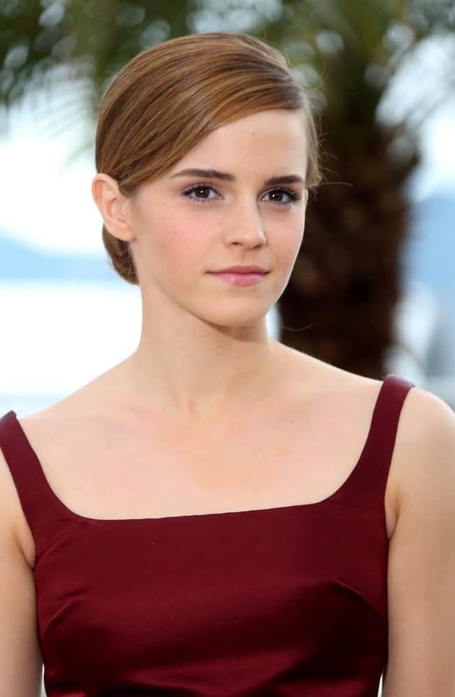 Emma Watson kept it simple with her make-up and neat side-swept low bun hairstyle with highlights at the 66th Cannes Film Festival - The Bling Ring photocall in Cannes, France on May 16, 2013.