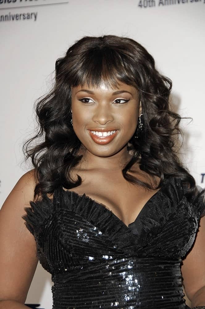 Jennifer Hudson attended the Los Angeles Free Clinic Annual Gala honoring Brad Grey in Beverly Hilton Hotel, Beverly Hills, CA on November 20, 2006. She was seen wearing a black strapless dress with her long and tousled raven curly hairstyle with wispy bangs.