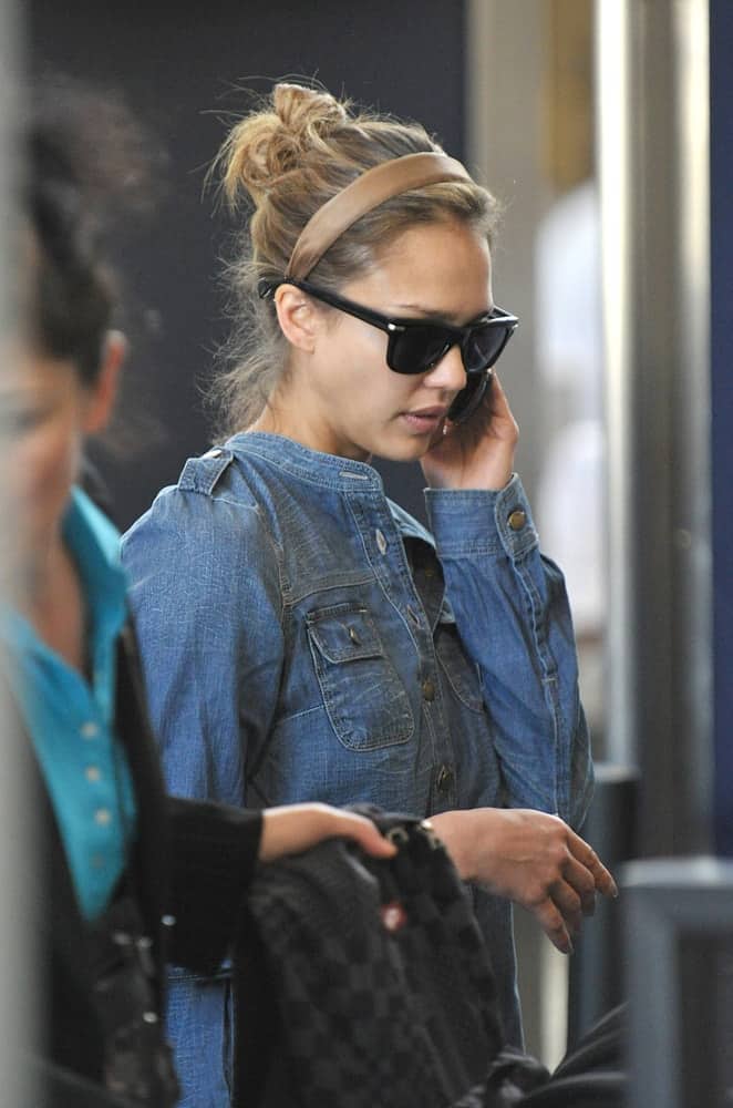Actress Jessica Alba was seen at LAX on November 11, 2010 in Los Angeles, California. She was walking with a casual denim jacket on to pair with her messy highlighted bun hairstyle that has a headband and loose tendrils.