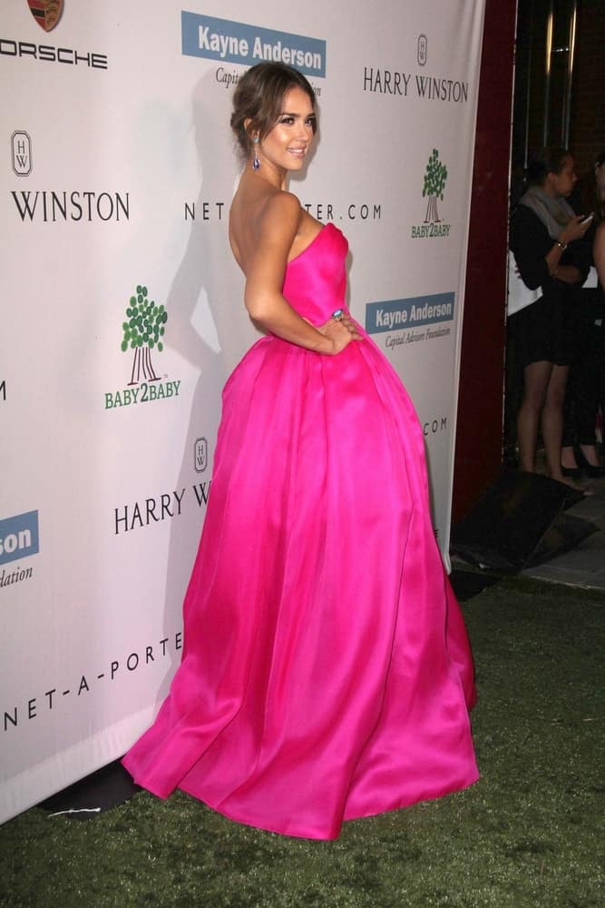Jessica Alba wore an elegant and lovely pink satin dress with her messy bun hairstyle that has loose long side bangs and subtle highlights at the Second Annual Baby2Baby Gala at Book Bindery on November 9, 2013 in Culver City, CA.