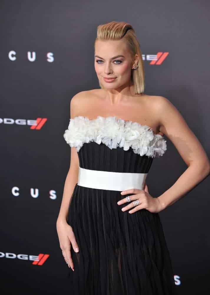 Margot Robbie looked daring in her black pleated dress complementing her bob-cut hair that's brushed up in the middle during the Los Angeles premiere of her movie "Focus" last February 24, 2015.