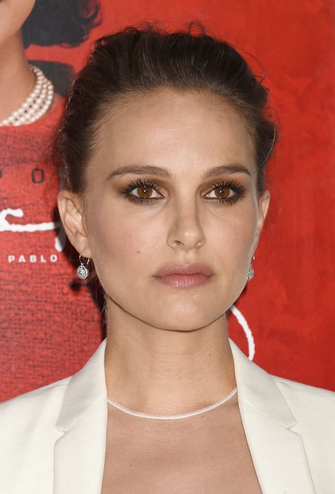 Natalie Portman's beautiful smokey eyes were perfect for her white smart casual outfit and tousled upstyle bun when she arrived at the AFI FEST 2016 "Jackie" Centerpiece Gala on November 14, 2016 in Hollywood, CA.