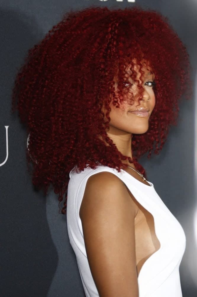 Rihanna was at the Gucci and RocNation Pre-GRAMMY Brunch held in West Hollywood, California on February 12, 2011. She came in a sexy white outfit to match with her thick red afro-style curly hair that is perfectly tousled.