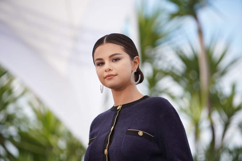 Selena Gomez attended the photocall for "The Dead Don't Die" during the 72nd annual Cannes Film Festival on May 15, 2019 in Cannes, France. She wore a lovely navy blue outfit to match her neat and slick low bun hairstyle.