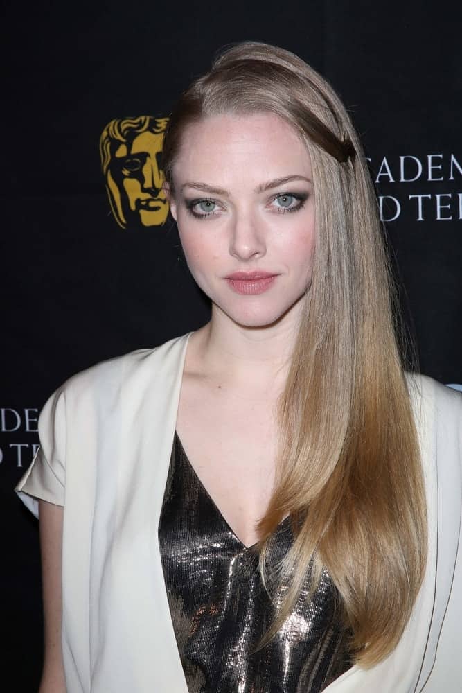 Amanda Seyfried flaunted her sexy eyes with smokey eye shadow and a long, side-swept sandy blond hairstyle that has a shiny straight finish at the BAFTA Los Angeles 2013 Awards Season Tea Party, Four Seasons Hotel in Los Angeles, CA on January 12, 2013.