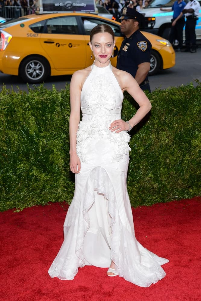On May 04, 2015, Amanda Seyfried attended the 'China: Through The Looking Glass' Costume Institute Gala, held at the Metropolitan Museum of Art in New York City, New York. She was elegant in her long white dress that she paired with a slick bun hairstyle.