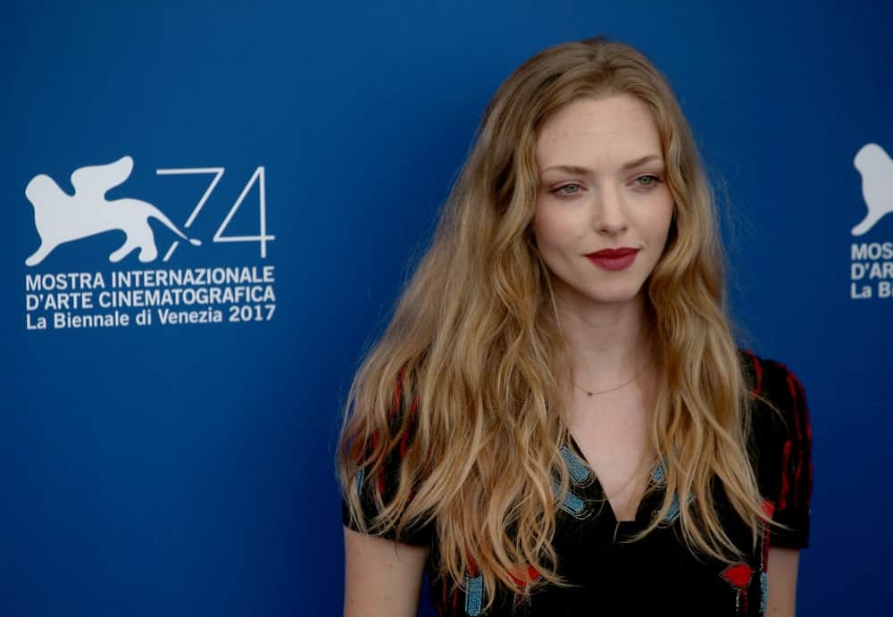 On August 31, 2017, Amanda Seyfried wore a casual black dress that she paired with her long sandy blond hair that was loose and tousled with subtle waves at the 'First Reformed' photocall during the 74th Venice Film Festival in Venice, Italy.