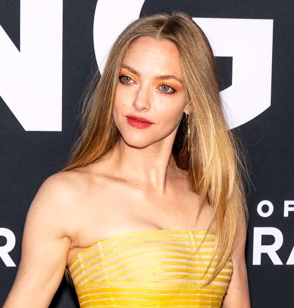 On August 01, 2019, Amanda Seyfried attended the premiere Of "The Art of Racing in the Rain" held at El Capitan Theatre. She wore a gorgeous yellow strapless dress that pairs quite well with her long and loose straight sandy blond hair with highlights.
