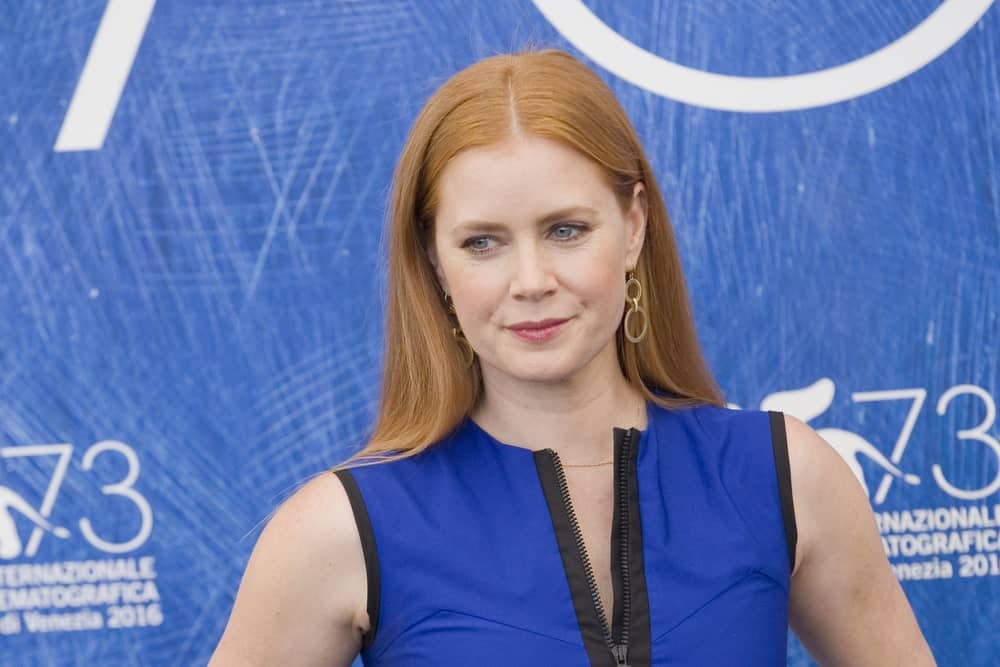 Amy Adams attended a photocall for 'Arrival' during the 73rd Venice Film Festival at Palazzo del Casino on September 1, 2016 in Venice, Italy. She came wearing a blue dress with her long and straight red hair tucked behind her ears.