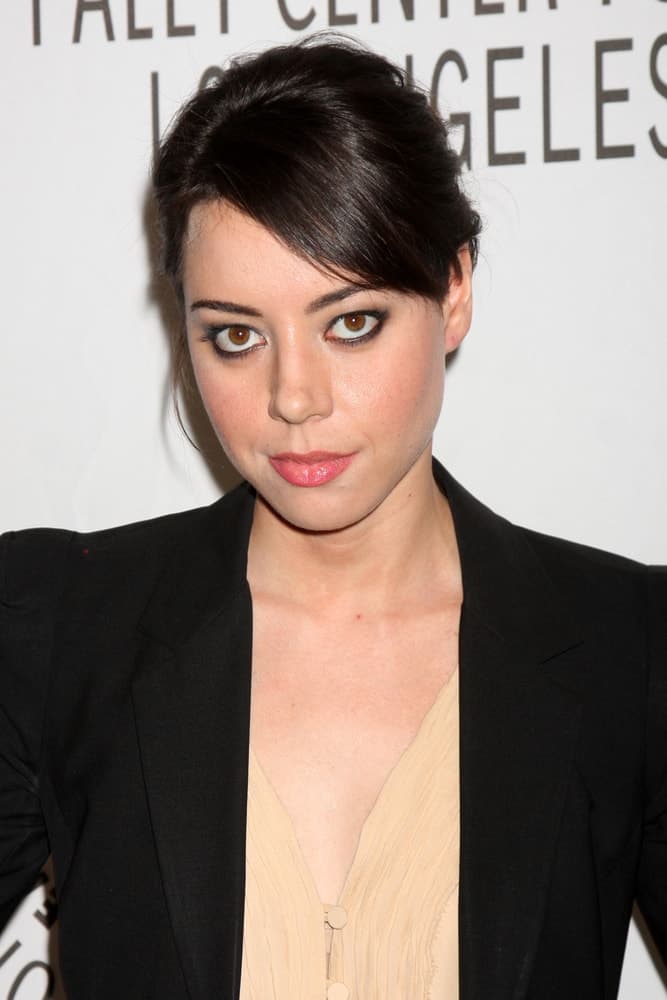 Aubrey Plaza was at the "Parks and Recreation" PaleyFest 2011 at Saban Theatre on March 9, 2011 in Beverly Hills, CA. She wore a smart casual outfit that she paired with her neat raven bun hairstyle that has side-swept bangs.