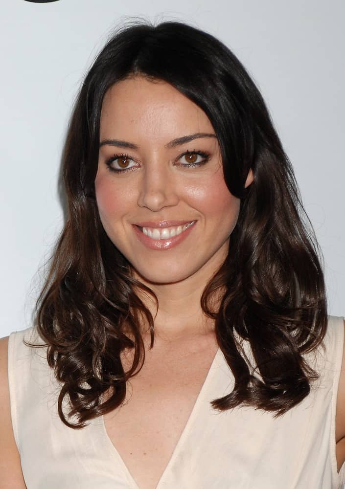 Aubrey Plaza was at the This Is 40 World Premiere on December 12, 2012 in Los Angeles, CA. She paired her lovely beige dress with a loose and tousled raven hairstyle with layers and curls at the tips. 