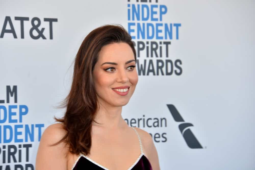 On February 23, 2019, Aubrey Plaza was at the 2019 Film Independent Spirit Awards in Santa Monica, CA. She was seen wearing a stunning black dress with her long side-swept and tousled dark hairstyle with layers and highlights.