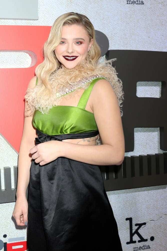Chloe Grace Moretz was at the "Suspiria" Premiere at the ArcLight Theaters on October 24, 2018, in Los Angeles, CA. She wore an edgy sexy dress to go with her platinum blonde highlighted and wavy side-swept hairstyle.