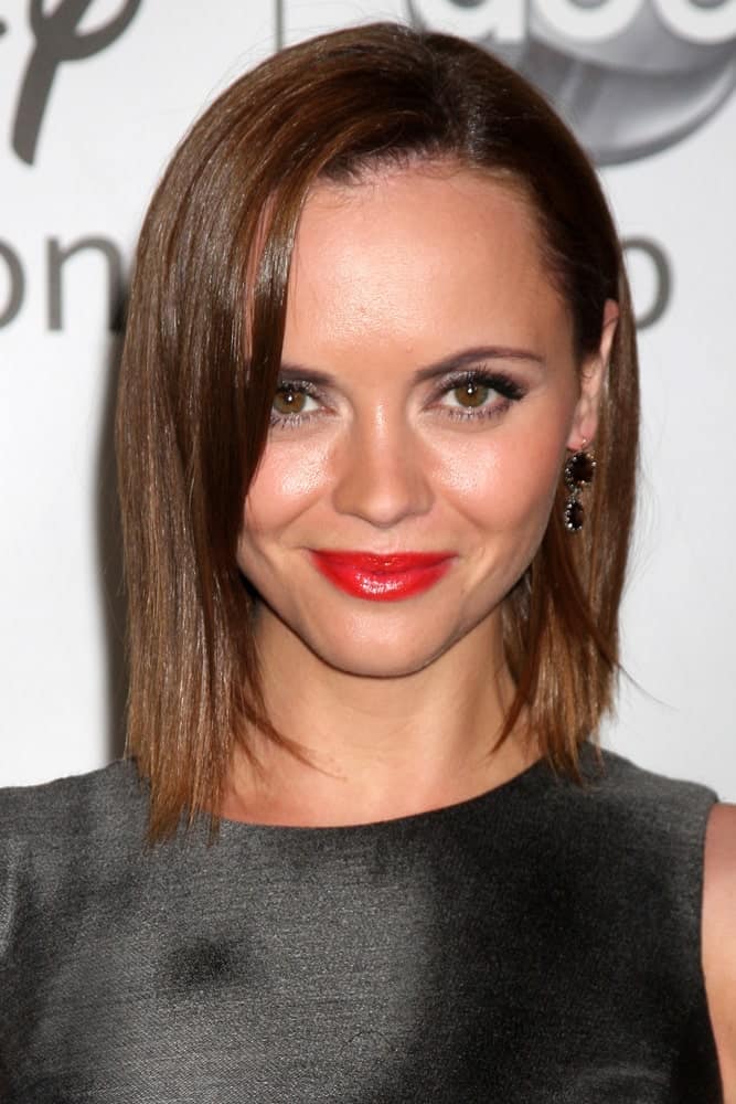 Christina Ricci was at the Disney / ABC Television Group 2011 Summer Press Tour Party at Beverly Hilton Hotel on August 7, 2011 in Beverly Hills, CA. She wore a black dress with her red lips and chin-length brunette bob hairstyle with a silky straight finish.