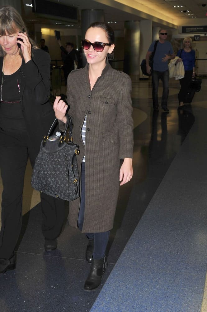 Actress Christina Ricci was spotted at LAX airport on October 30, 2011 in Los Angeles, California. SHe was seen wearing a winter coat, a pair of sunglass and a slicked back ponytail hairstyle.