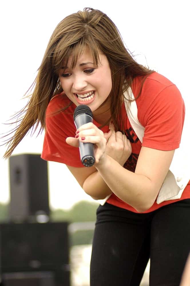 Demi Lovato performed on stage for Concert at the Quick Chek New Jersey Festival of Ballooning held at the Solberg Airport in Readington, NJ on July 26, 2008. She wore a simple casual outfit with her loose and straight brunette brown hairstyle with tousled bangs.