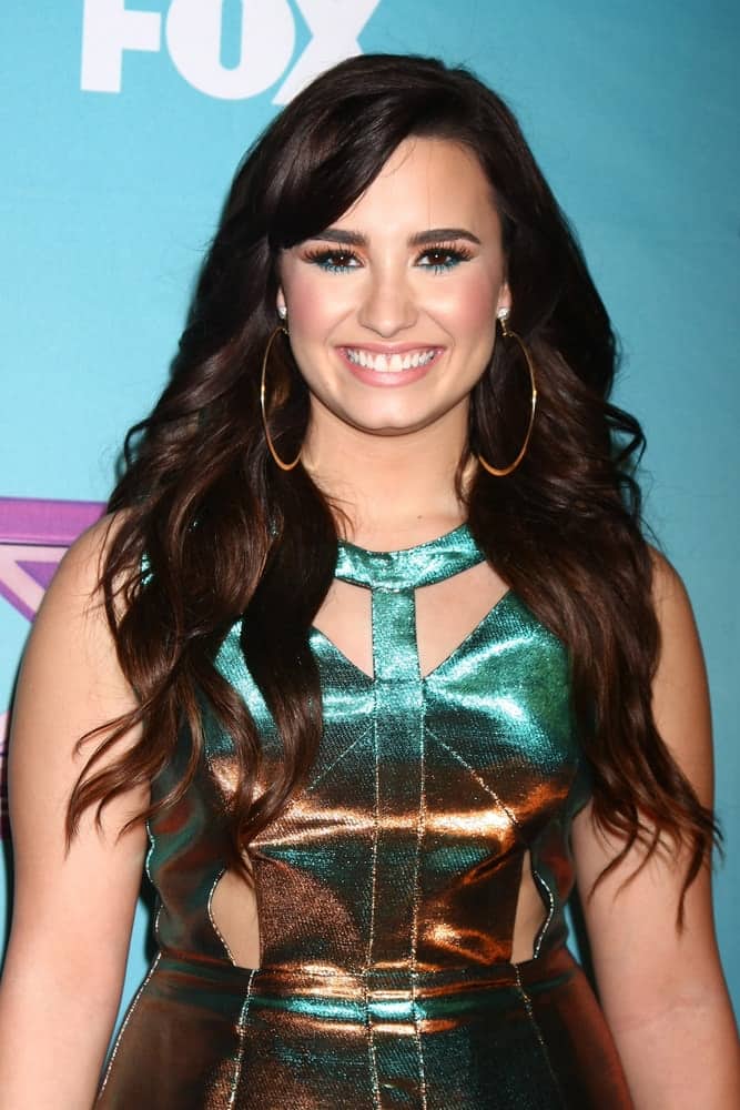 Demi Lovato was quite charming in her shiny dress and long wavy tousled dark hairstyle that has long side-swept bangs at the 'X Factor' Season Finale at CBS Television City on December 20, 2012 in Los Angeles, CA.
