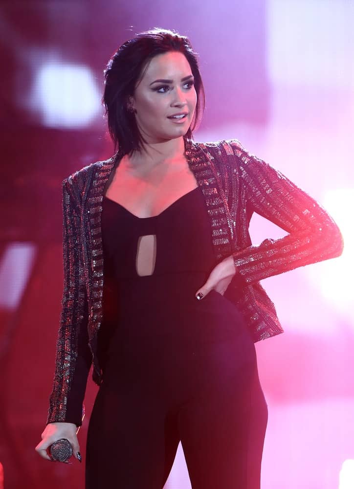 Recording artist Demi Lovato wore an all-black outfit with her glittery jacket and chin-length straight hair with a slight tousle when she performed during CBS RADIO's third annual We Can Survive at the Hollywood Bowl on October 24, 2015 in Hollywood, California.