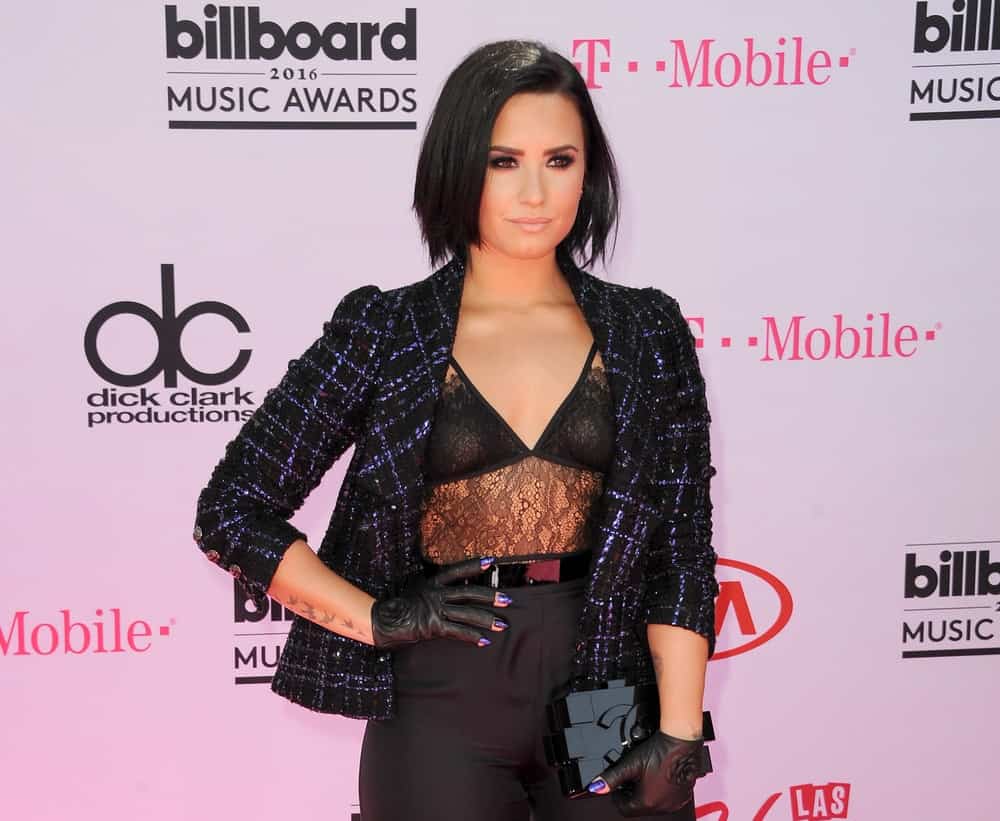 Demi Lovato wore an all-black sexy ensemble outfit with her short and straight side-swept raven bob hairstyle with a slight tousle at the 2016 Billboard Music Awards held at T-Mobile Arena in Las Vegas, USA on May 22, 2016.