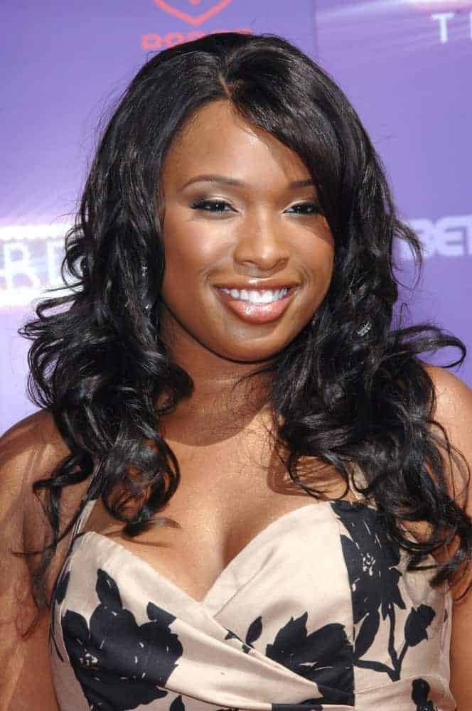 Jennifer Hudson attended the 2007 BET Awards at the Shrine Auditorium, Los Angeles on June 26, 2007. She was charming in a strapless dress that she paired with a long and curly raven hairstyle with a slight tousle and side-swept bangs.