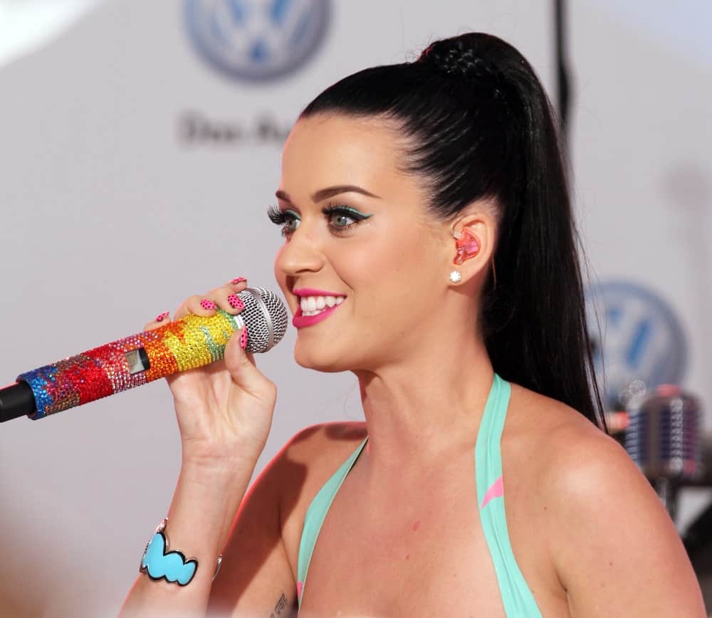 The singer performing at the world premiere of Volkswagen's new Jetta compact sedan at Times Square on June 15, 2010 with her long jet black hair slicked back into a high braided ponytail.