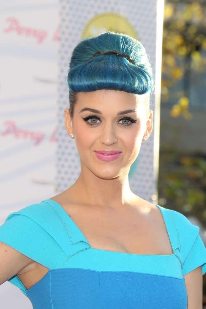 Katy Perry matched her blue outfit with a sleek updo featuring her bumper bangs during the Launch of