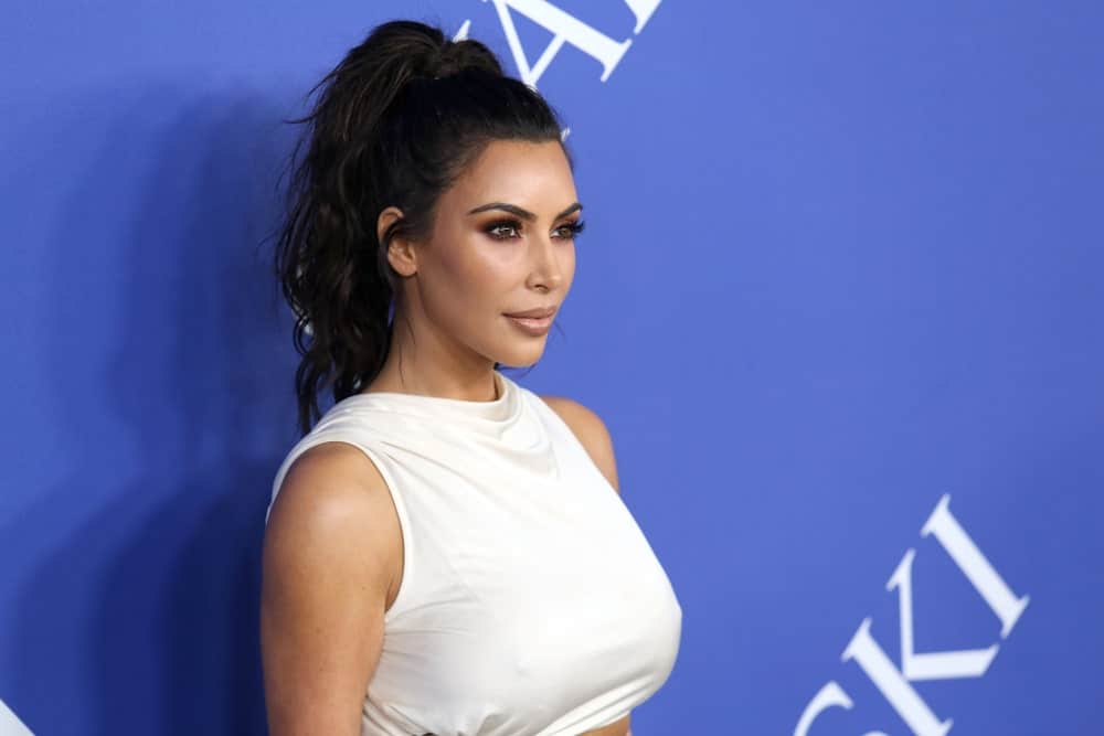 Kim Kardashian gathered her black hair in a tousled ponytail with side tendrils at the CFDA Awards at the Brooklyn Museum on June 4, 2018.