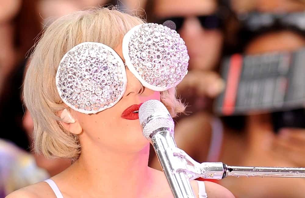 Lady Gaga performed on stage for NBC Today Show Concert with Lady Gaga in Rockefeller Plaza, New York on July 9, 2010. She wore a white mask and white outfit to go with her bold red lips and a short white blond hairstyle with short bangs.