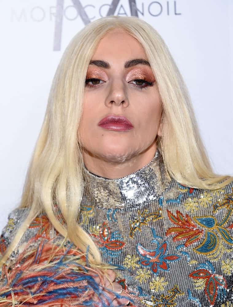 Lady Gaga wore a colorful bodysuit with floral details and silver sequins to go with her long, straight center-parted white blond hair when she arrived at the 2nd Annual Fashion Los Angeles Awards on March 20, 2016 in Hollywood, CA.