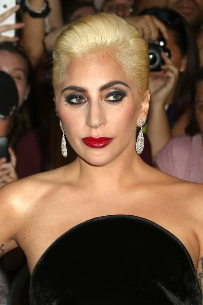 Lady Gaga opted for a vintage look to go with her beautiful black velvet dress. She wore a bold make-up and a neat slick upstyle when she was seen on August 3, 2016, in New York City.