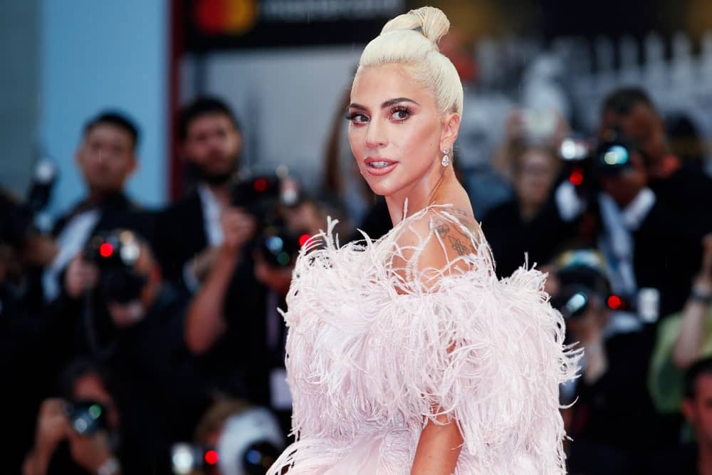 Lady Gaga wowed everyone with her absolutely stunning frilly white dress that went great with her white blond hair that is styled up into a top knot at the premiere of her movie 'A Star Is Born' during the 75th Venice Film Festival on August 31, 2018 in Venice, Italy.