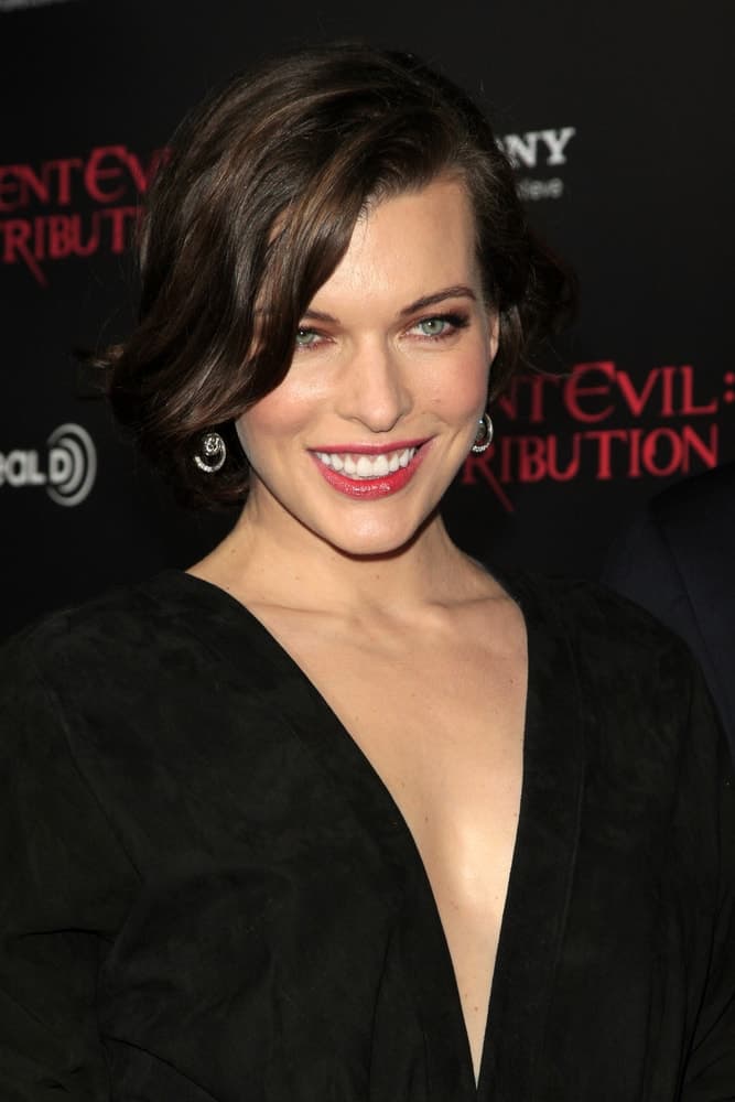 Milla Jovovich was at the "Resident Evil: Retribution" Premiere at Regal Cinemas L.A. Live on September 12, 2012 in Los Angeles, CA. She wore a black dress with her chin-length raven hairstyle that has long side-swept bangs.