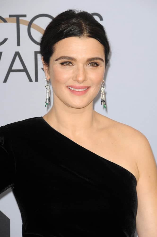 On January 27, 2019, Rachel Weisz was seen at the 25th Annual Screen Actors Guild Awards sporting a center-parted updo. She finished it off with a black halter dress and dangling earrings.