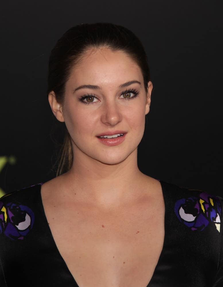 Shailene Woodley attended the "Hunger Games" World Premiere on March 12, 2012 in Los Angeles, CA. She was seen wearing a charming black dress with her slicked-back raven ponytail hairstyle.