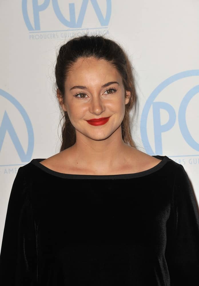 Shailene Woodley was at the 23rd Annual Producers Guild Awards at the Beverly Hilton Hotel on January 21, 2012 in Los Angeles, CA. She emphasized her red lips with a black dress and a simple brunette ponytail hairstyle that has loose tendrils.