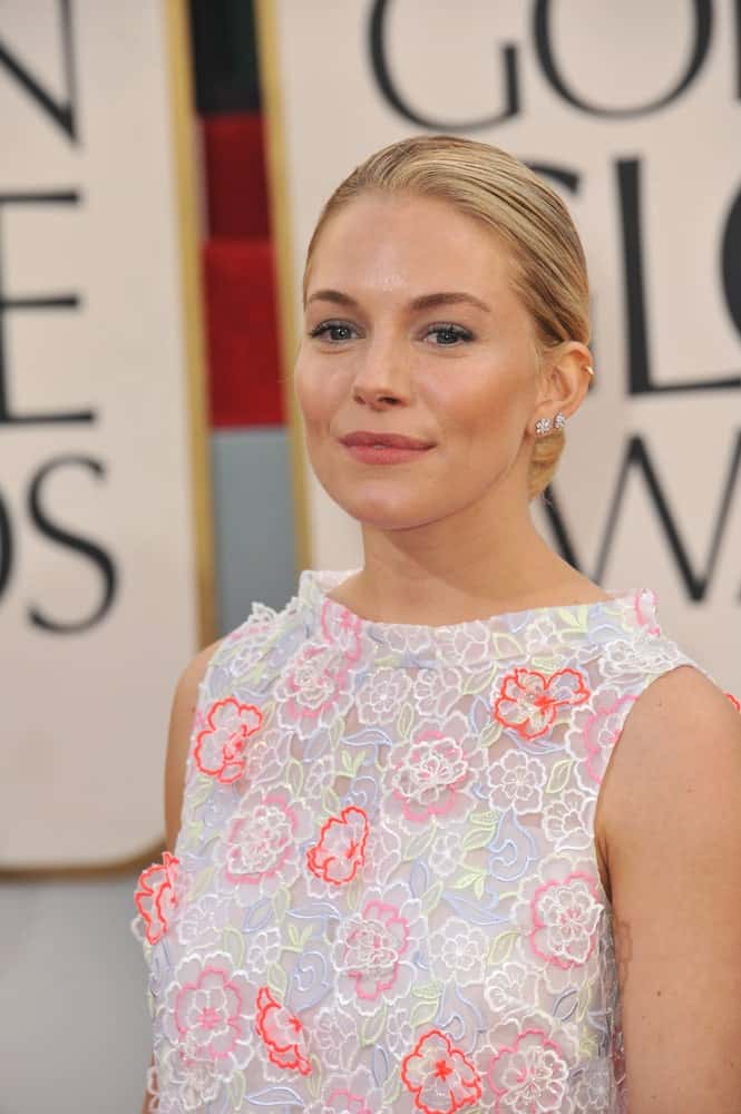Sienna Miller showcases a sweet aura in a floral dress and neat, low bun hairstyle at the 70th Golden Globe Awards on January 13, 2013.