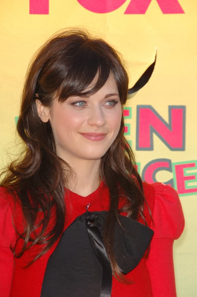 Actress Zooey Deschanel was at the 2006 Teen Choice Awards at Universal City, Hollywood on August 20, 2006. She was lovely in a red dress that she paired with her long dark hairstyle that is tousled and loose with side-swept bangs.