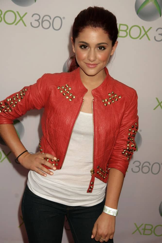 Ariana Grande kept it casual in a loose ponytail along with a white tank top and red jacket at the World Premiere of "Project Natal" for XBOX 360 Imagined by Cirque Du Soleil on June 13, 2010.
