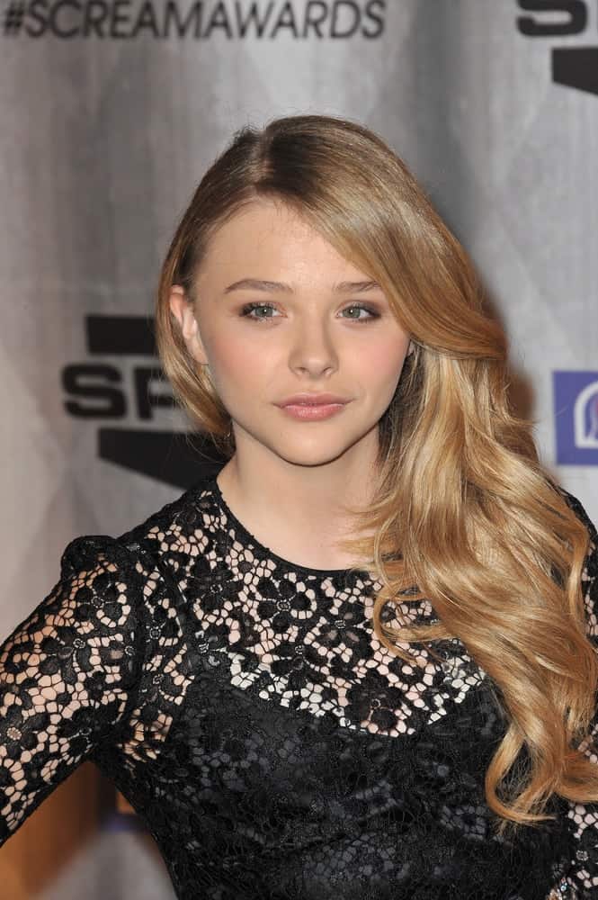 Chloe Grace Moretz was at the 2011 Spike TV Scream Awards at Universal Studios, Hollywood on October 15, 2011. She was charming in a black sheer dress that went perfectly well with her long and wavy side-swept hairstyle with layer and highlights.