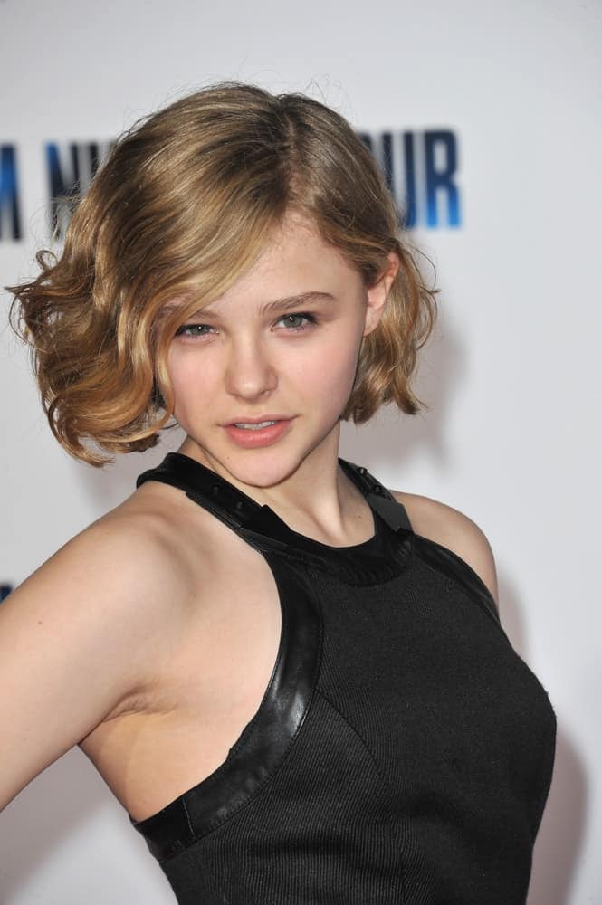 Chloe Grace Moretz was at the world premiere of "I Am Number Four" at the Mann Village Theatre, Westwood on February 9, 2011 Los Angeles, CA. She was stunning in her black dress and chin length sandy blonde hair with waves and side-swept bangs.